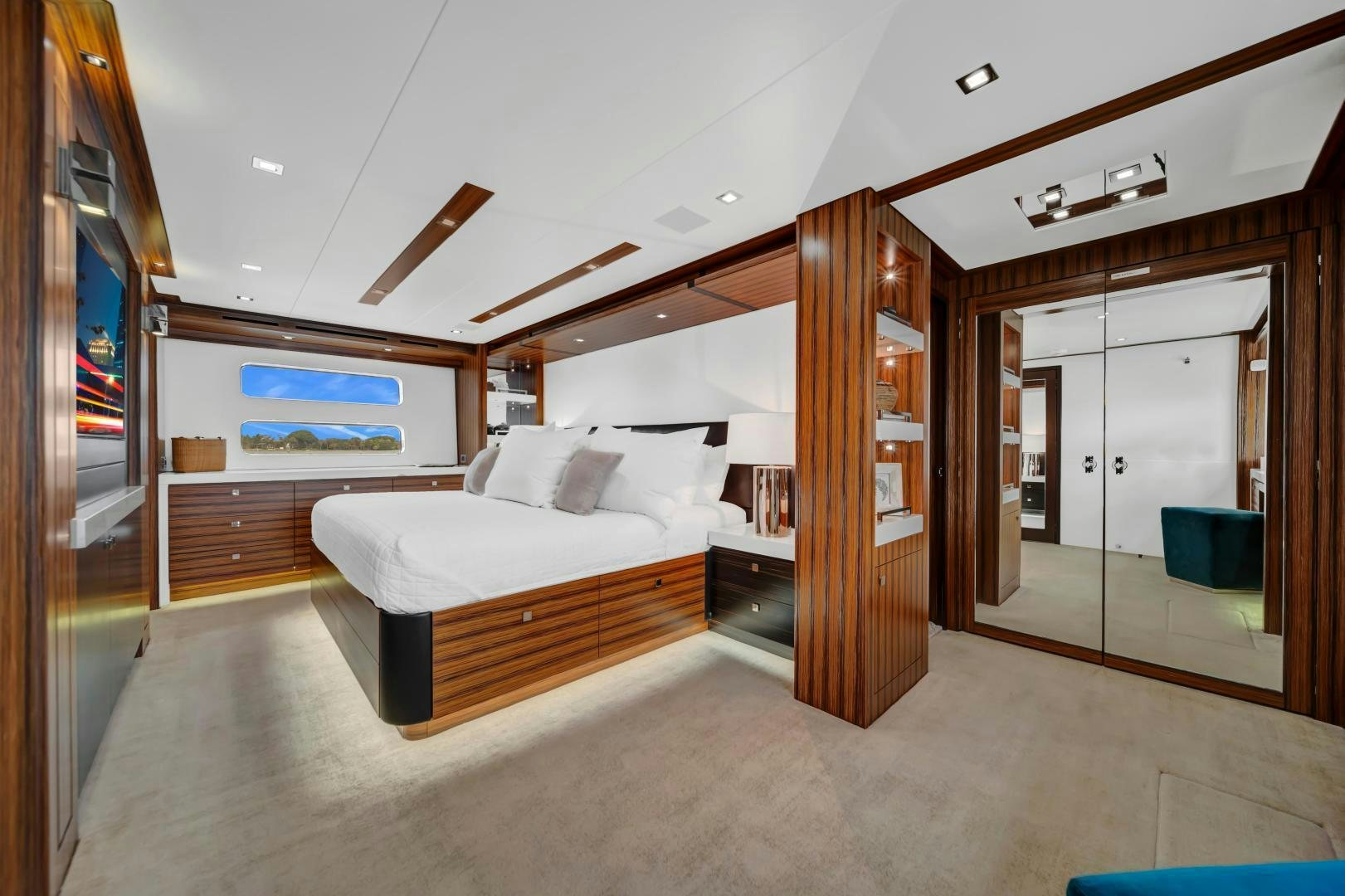 a bedroom with a bed and a wood door aboard ON Q Yacht for Sale
