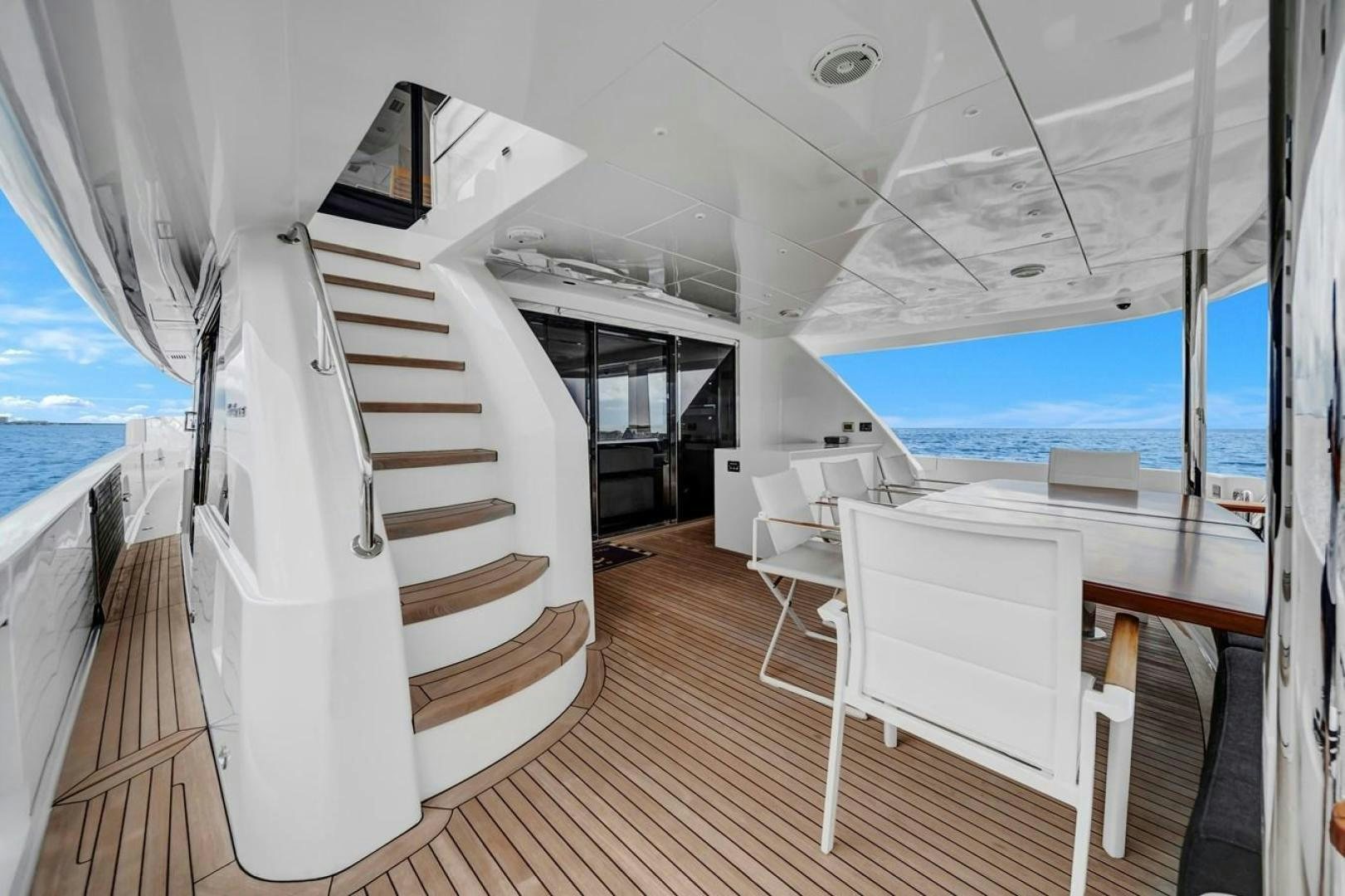 a room with a white bed and a white chair aboard ON Q Yacht for Sale