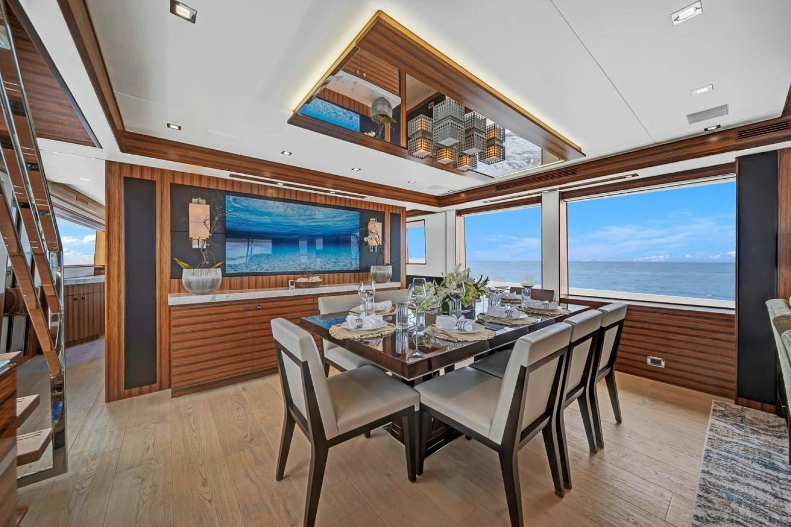 a dining table in a room aboard ON Q Yacht for Sale
