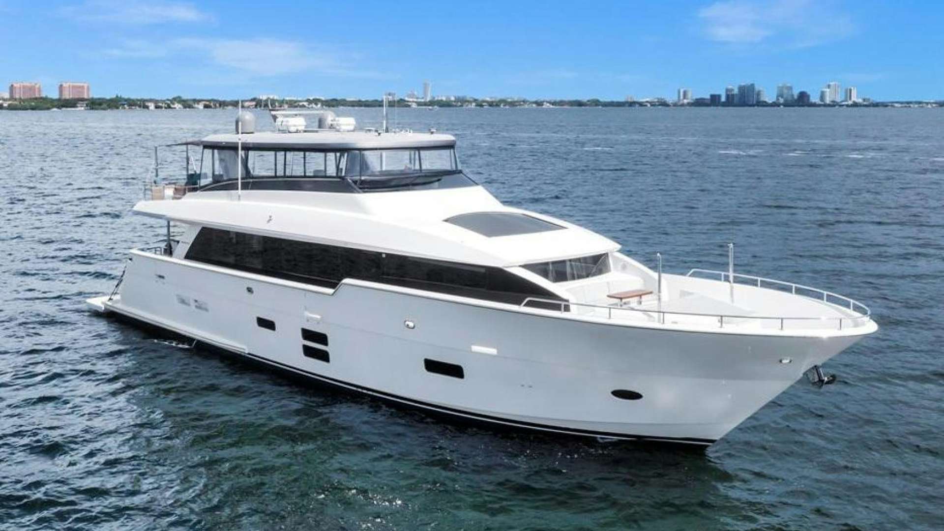 a white yacht on the water aboard ON Q Yacht for Sale