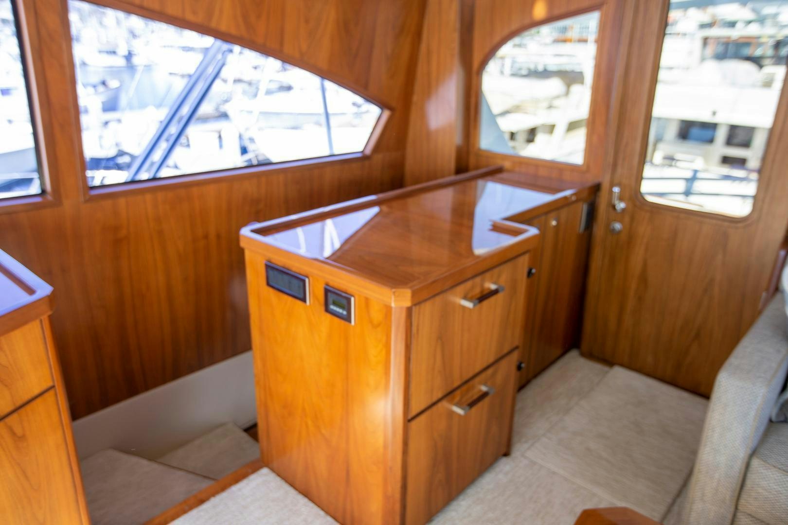 a room with a dresser and a window aboard REEL HIGH'S Yacht for Sale