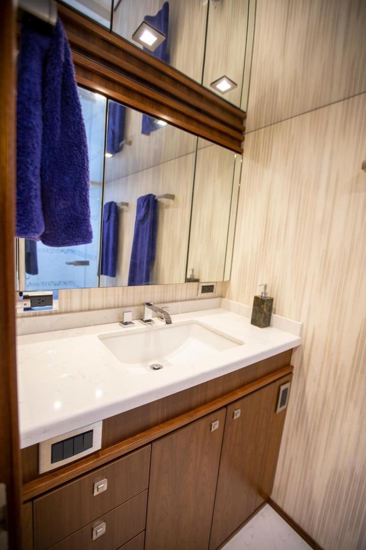 a bathroom with a sink and a mirror aboard REEL HIGH'S Yacht for Sale