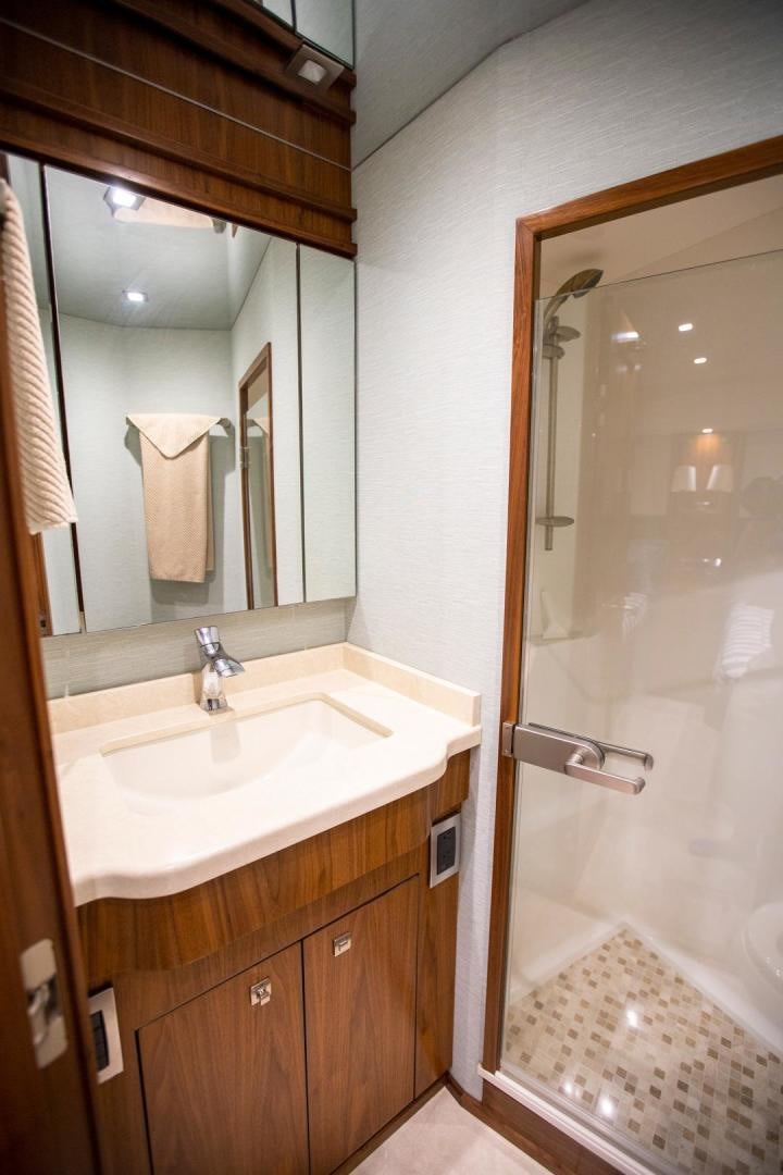 a bathroom with a mirror and sink aboard REEL HIGH'S Yacht for Sale