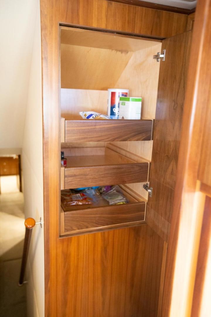 a wooden cabinet with shelves aboard REEL HIGH'S Yacht for Sale