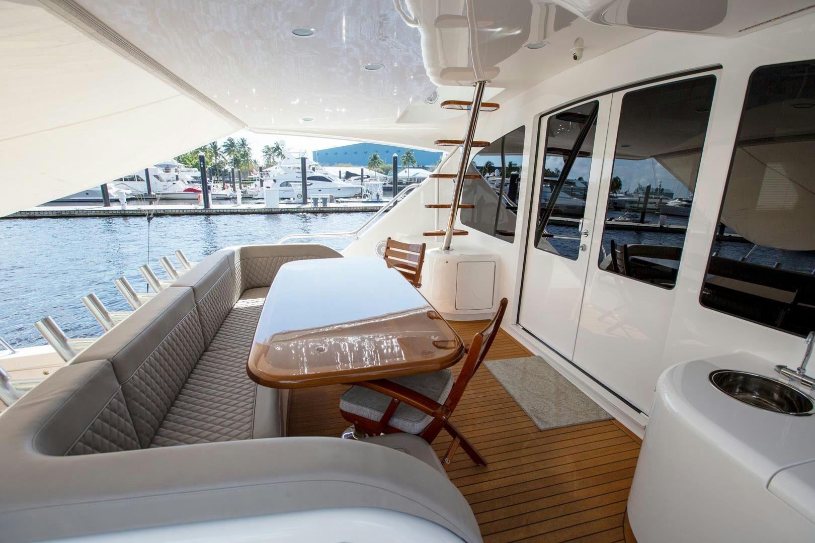 a boat with a table and chairs on a deck aboard REEL HIGH'S Yacht for Sale