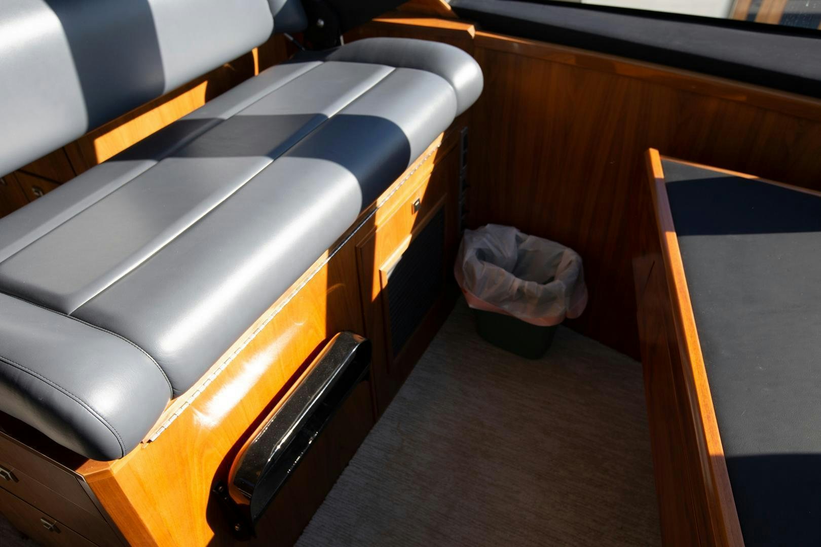 a room with a couch and a bag aboard REEL HIGH'S Yacht for Sale