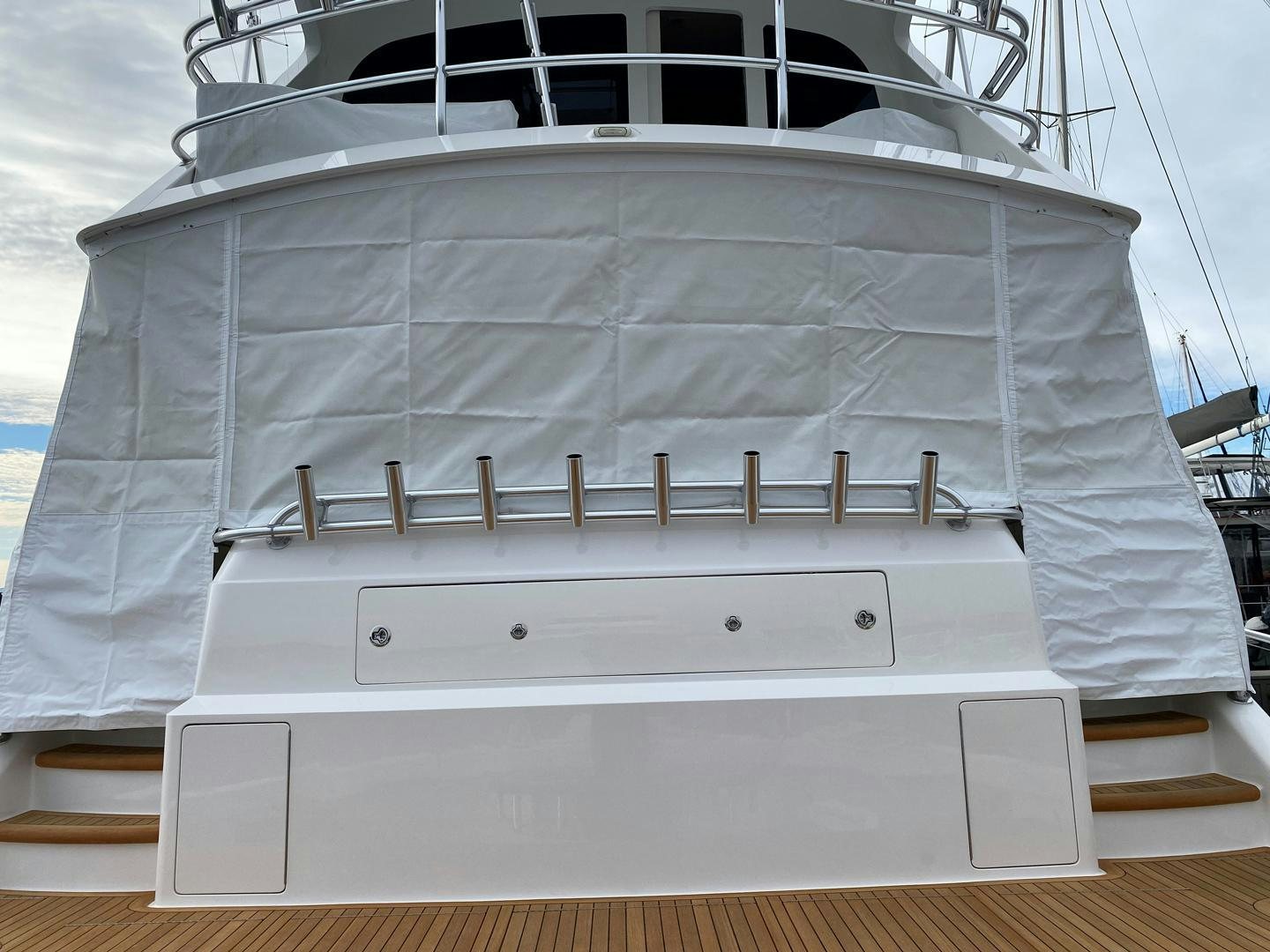 a white boat with a wooden deck aboard REEL HIGH'S Yacht for Sale