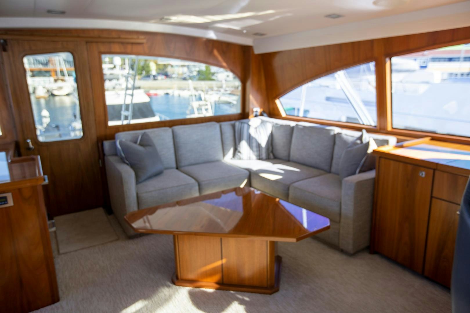 a living room with a couch and a coffee table aboard REEL HIGH'S Yacht for Sale
