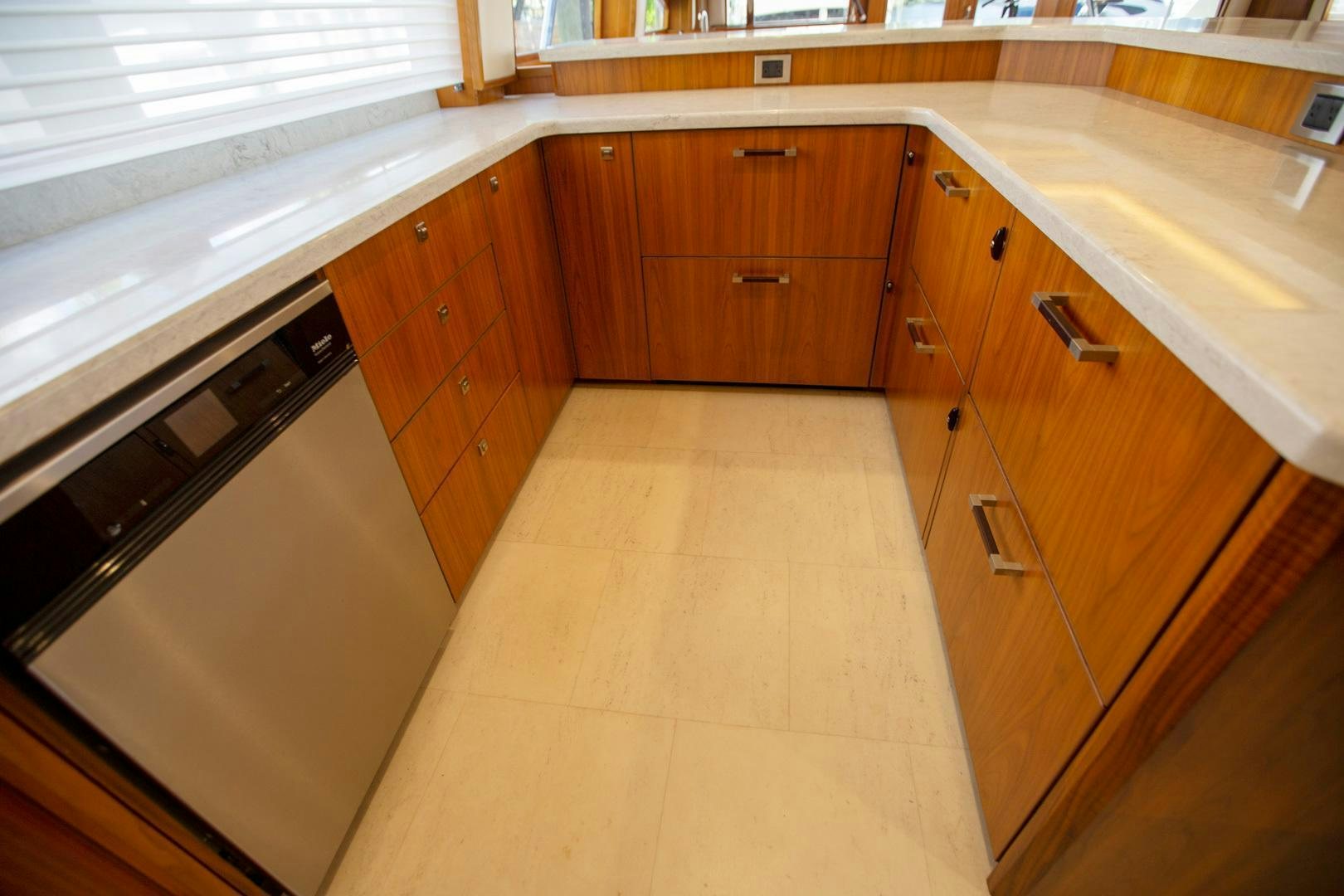 a kitchen with wooden cabinets aboard REEL HIGH'S Yacht for Sale