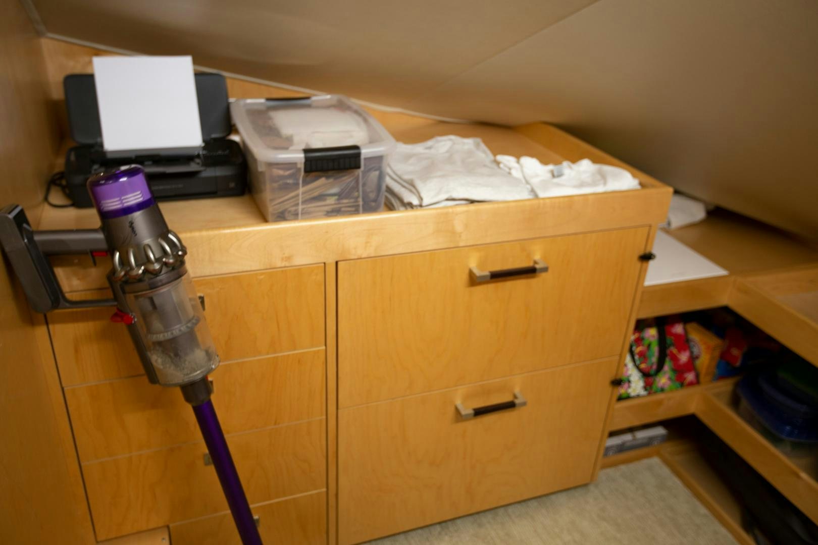 a desk with a computer and other objects on it aboard REEL HIGH'S Yacht for Sale