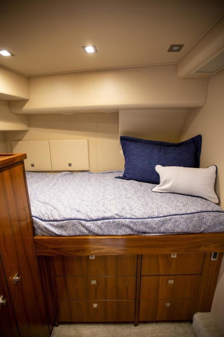 a bed with blue and white sheets aboard REEL HIGH'S Yacht for Sale
