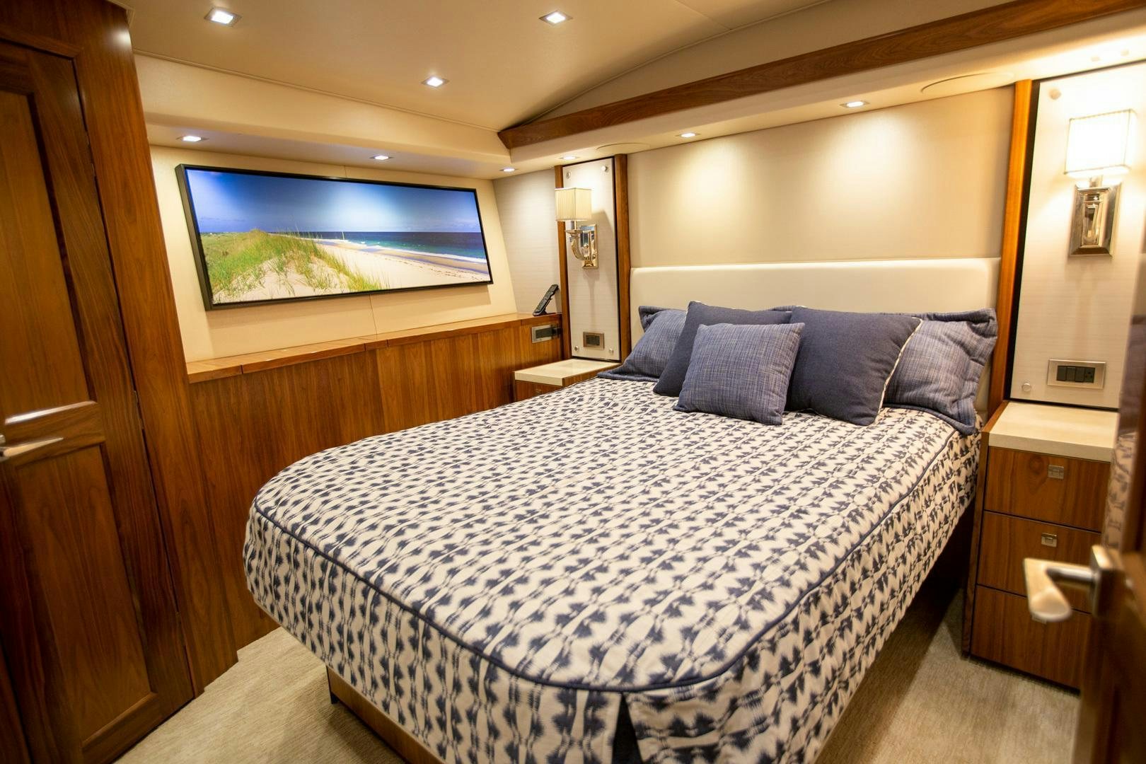 a bed with a blue and white comforter and pillows aboard REEL HIGH'S Yacht for Sale