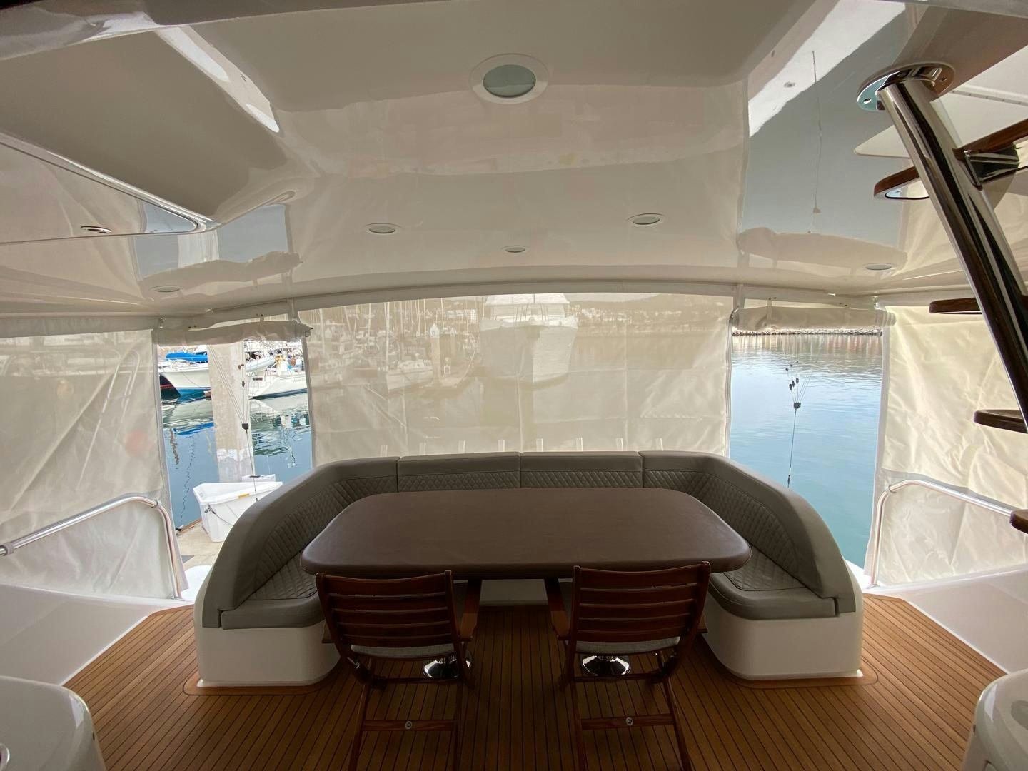 a room with a table and chairs aboard REEL HIGH'S Yacht for Sale