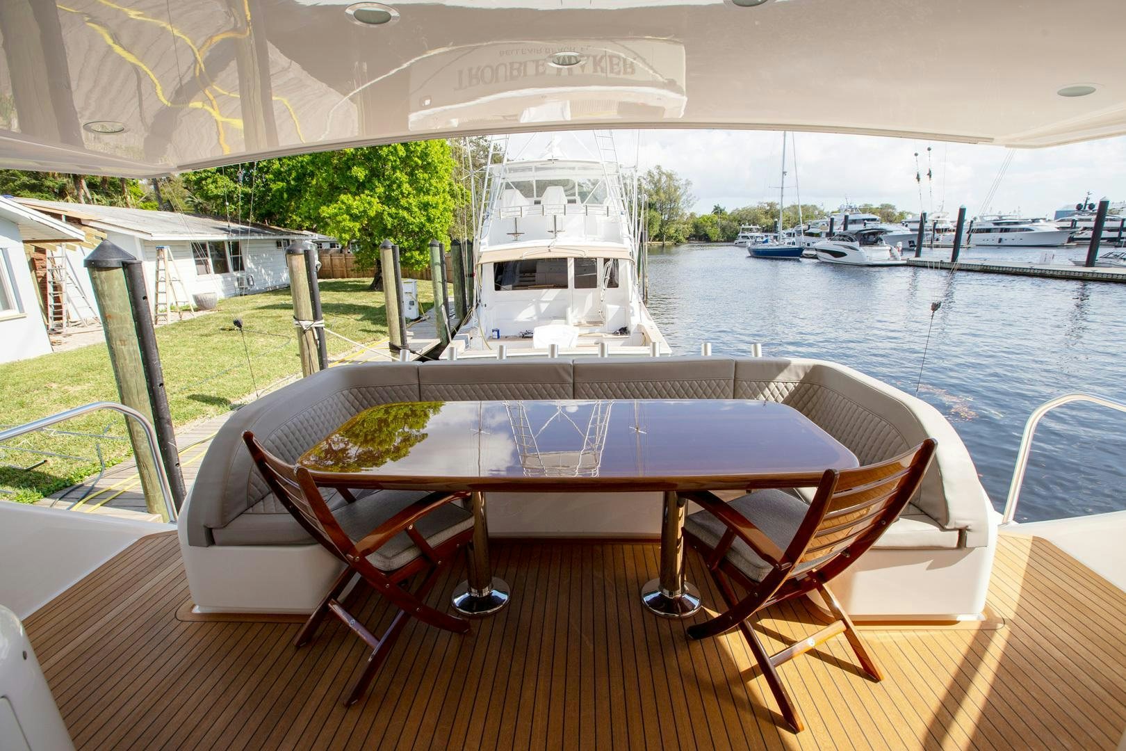 a table on a deck overlooking a body of water aboard REEL HIGH'S Yacht for Sale