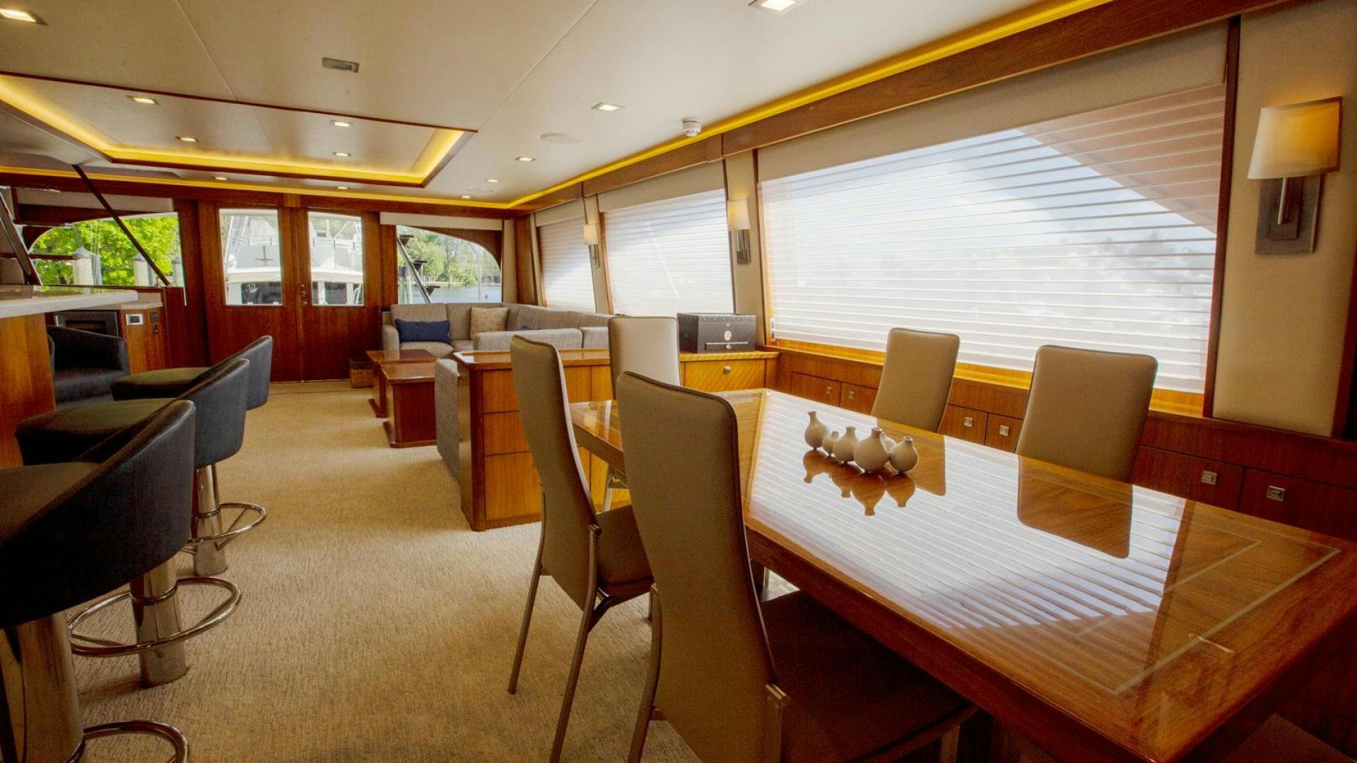 a room with tables and chairs aboard REEL HIGH'S Yacht for Sale