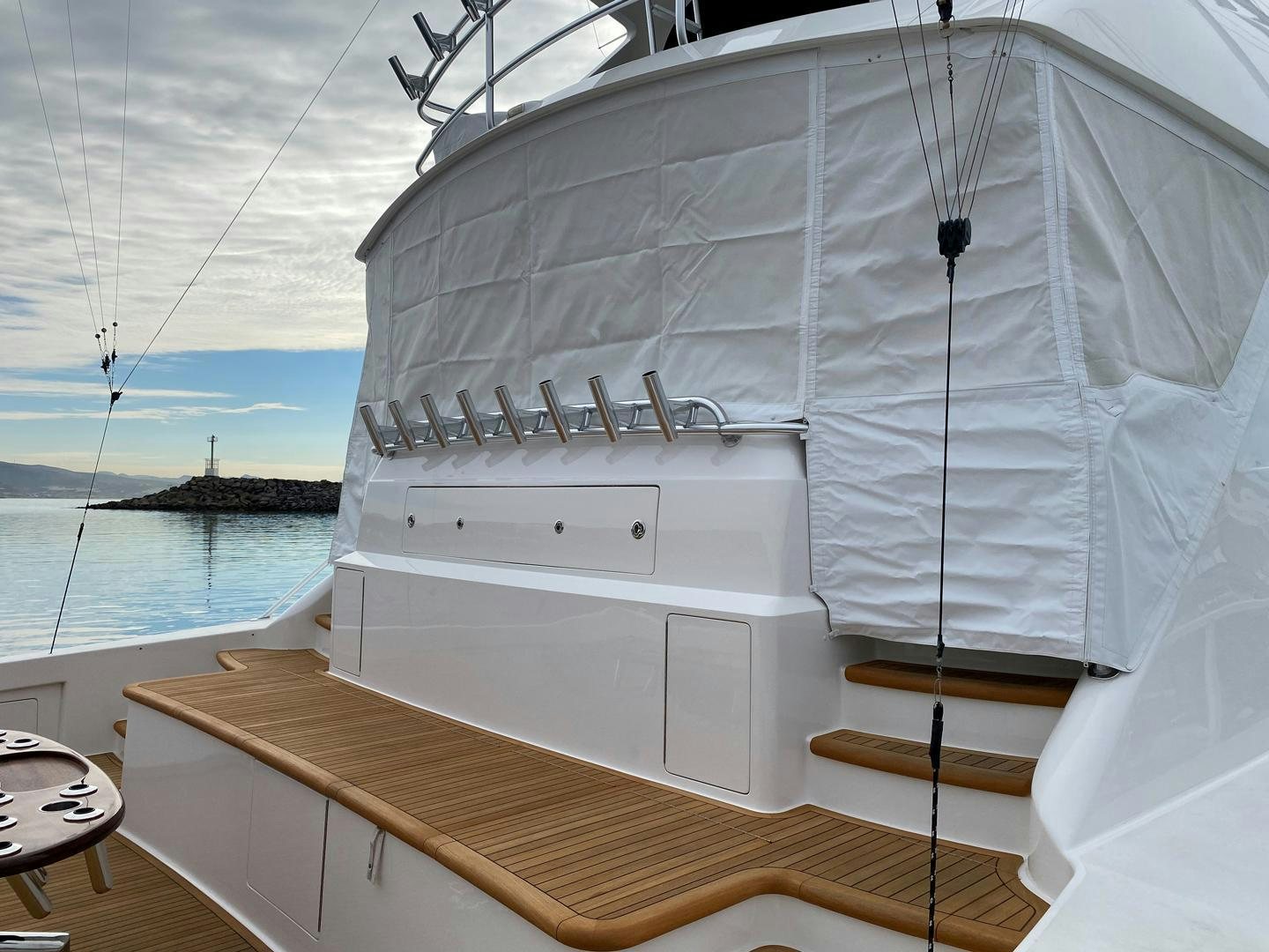 a white boat with a white canopy aboard REEL HIGH'S Yacht for Sale