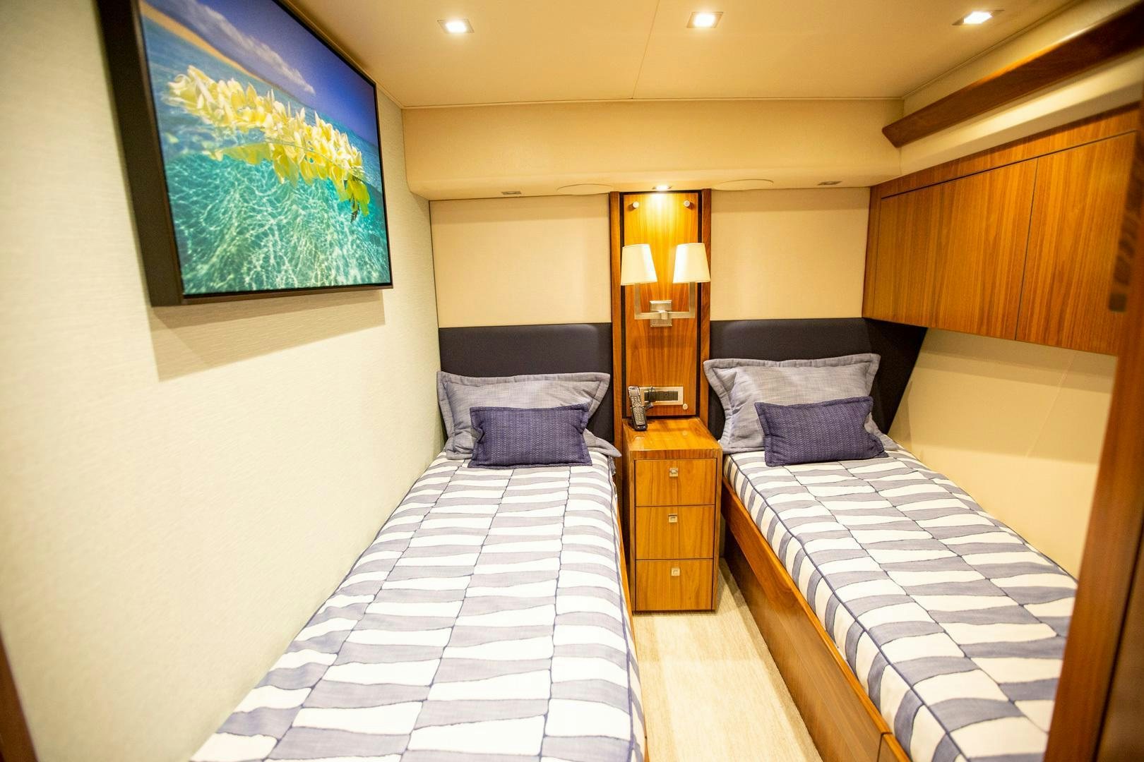 a room with a couple beds aboard REEL HIGH'S Yacht for Sale