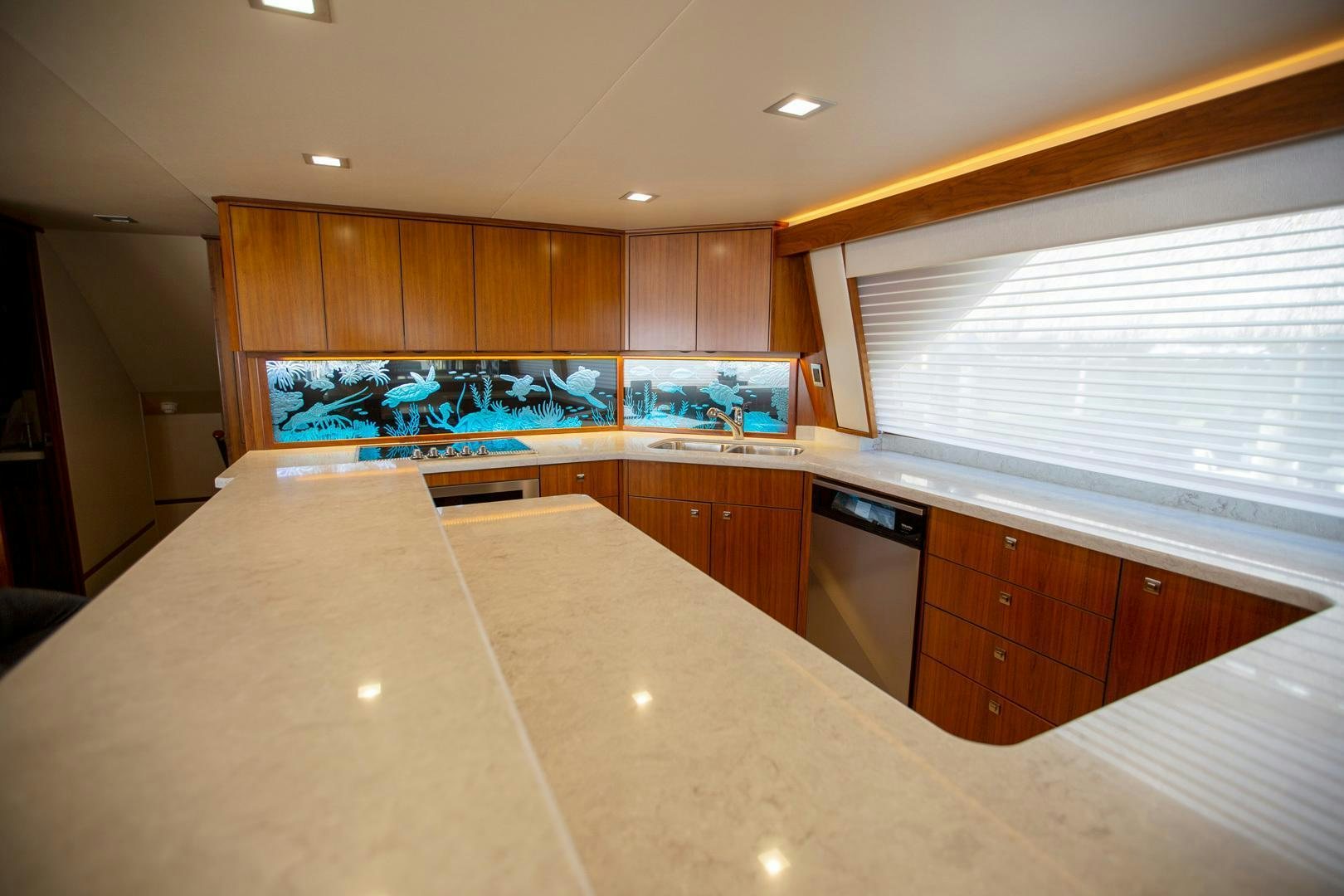 a kitchen with wooden cabinets aboard REEL HIGH'S Yacht for Sale
