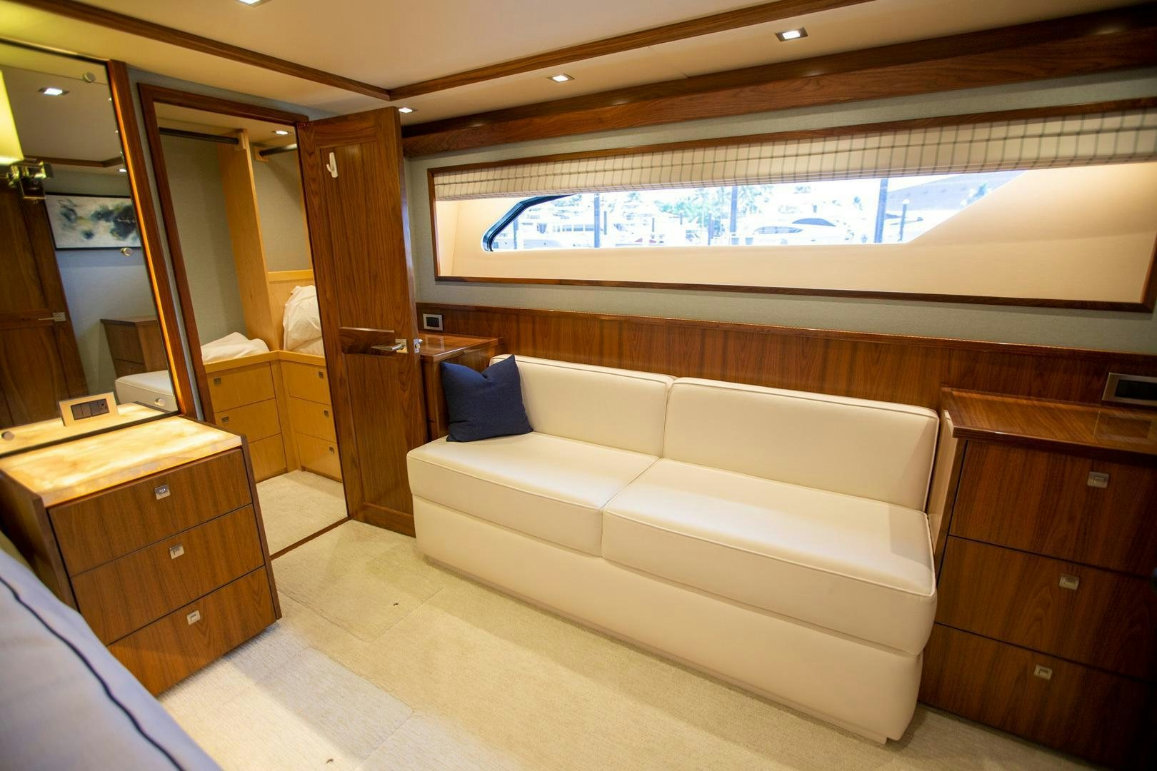 a room with a couch and a dresser aboard REEL HIGH'S Yacht for Sale
