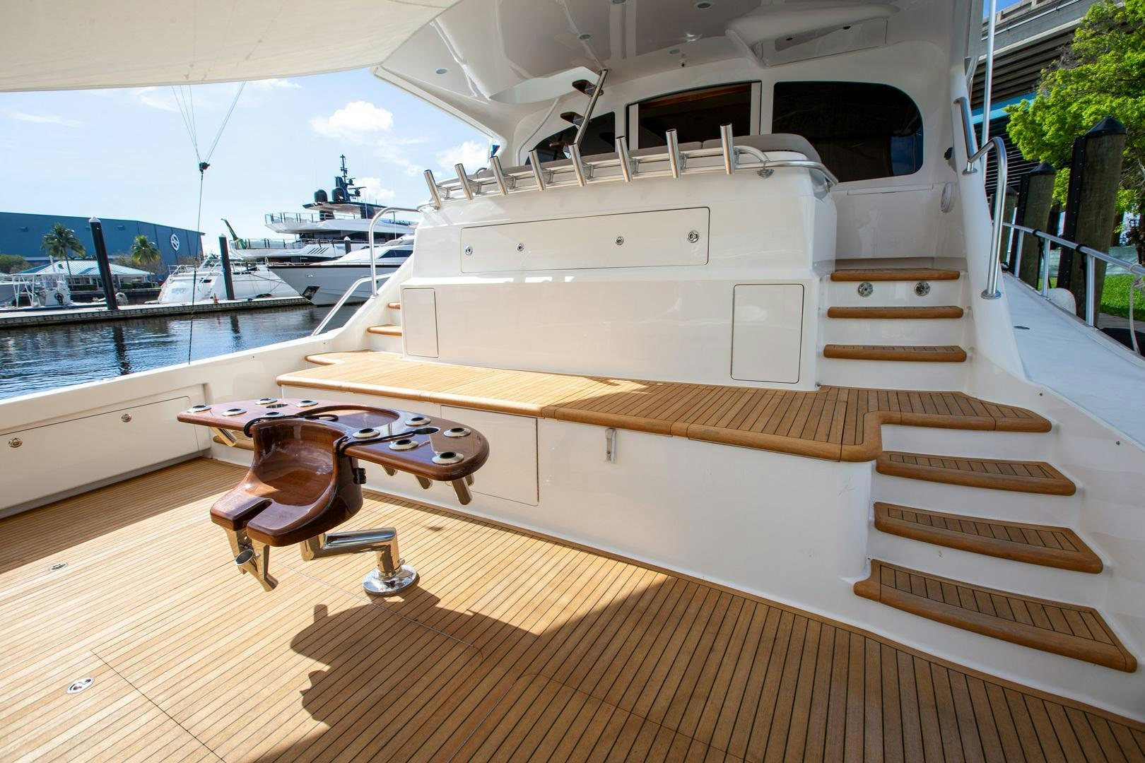a deck with a table and chairs on it aboard REEL HIGH'S Yacht for Sale