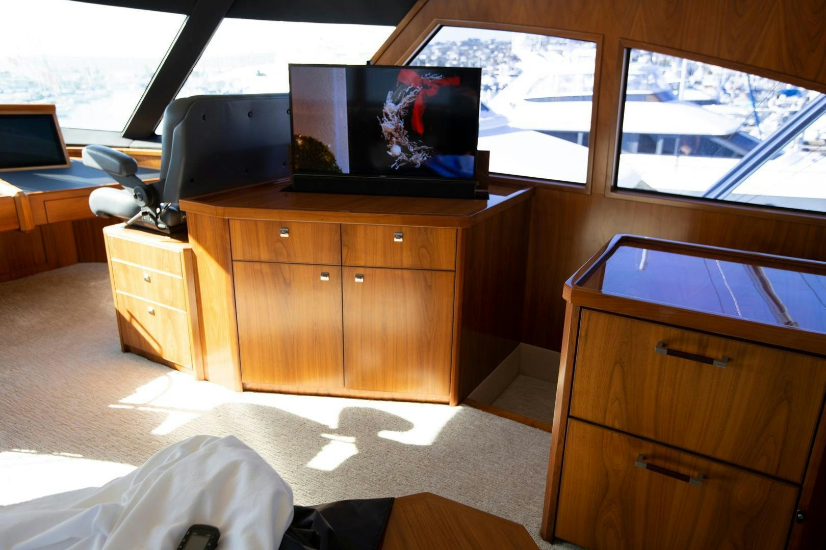 a room with a tv and a dresser aboard REEL HIGH'S Yacht for Sale
