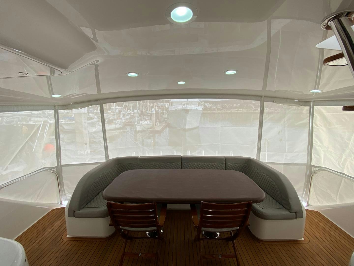a room with a table and chairs aboard REEL HIGH'S Yacht for Sale