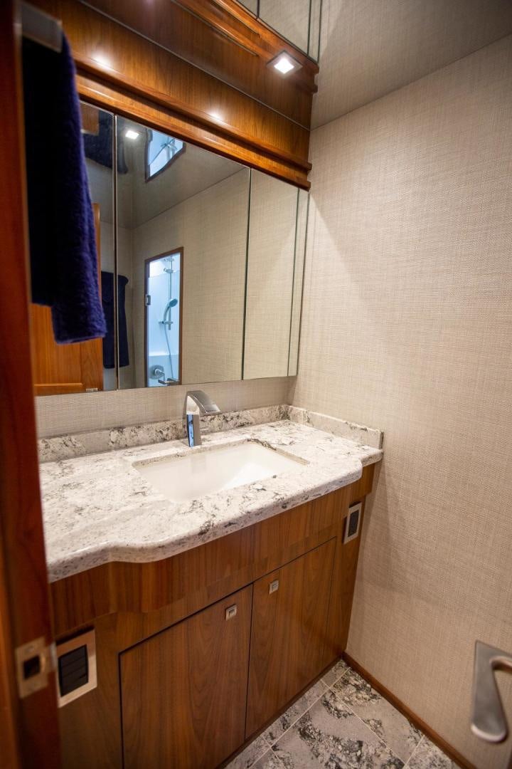 a bathroom with a large mirror aboard REEL HIGH'S Yacht for Sale