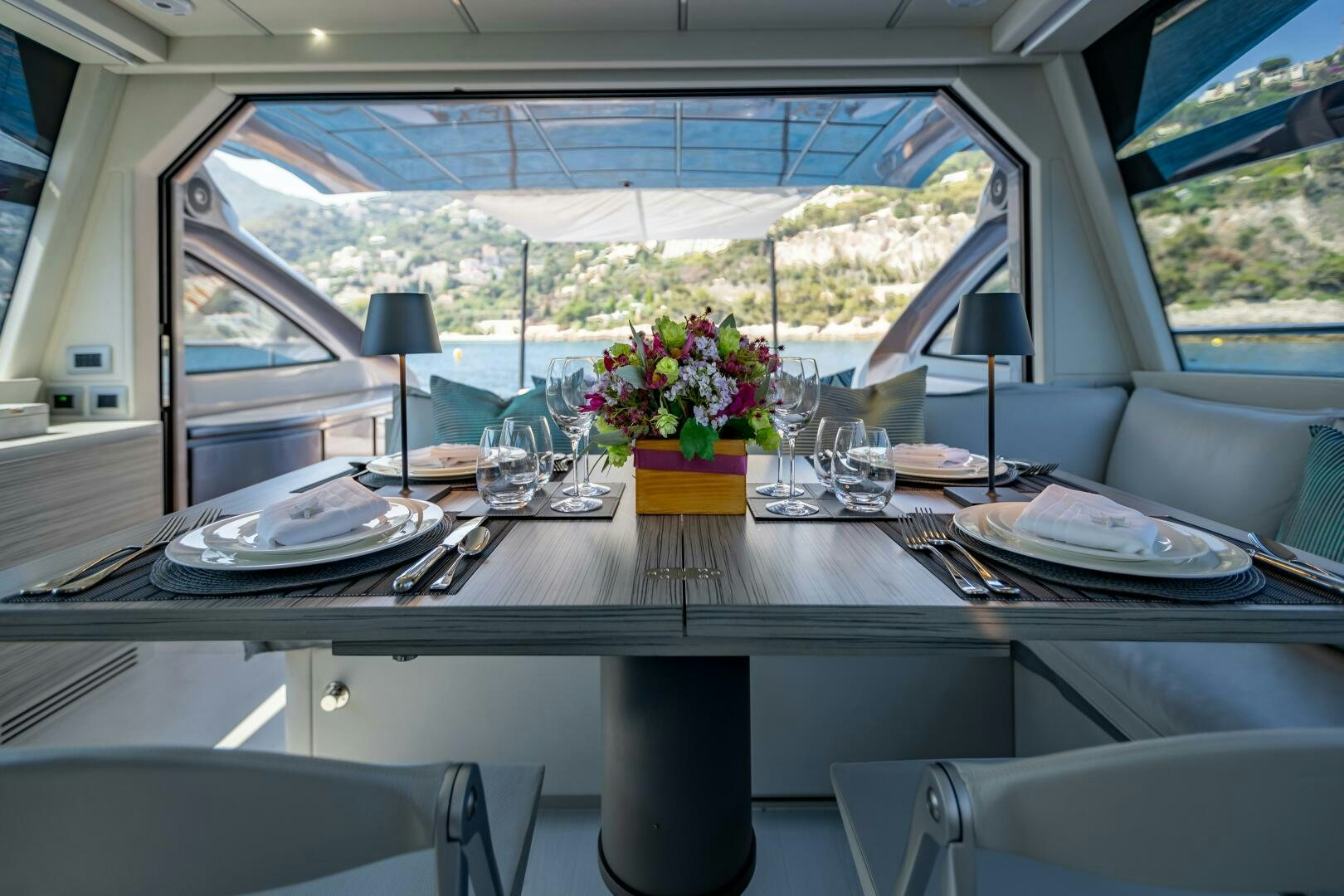a table with plates and glasses on it aboard SILVER MISSILE Yacht for Sale