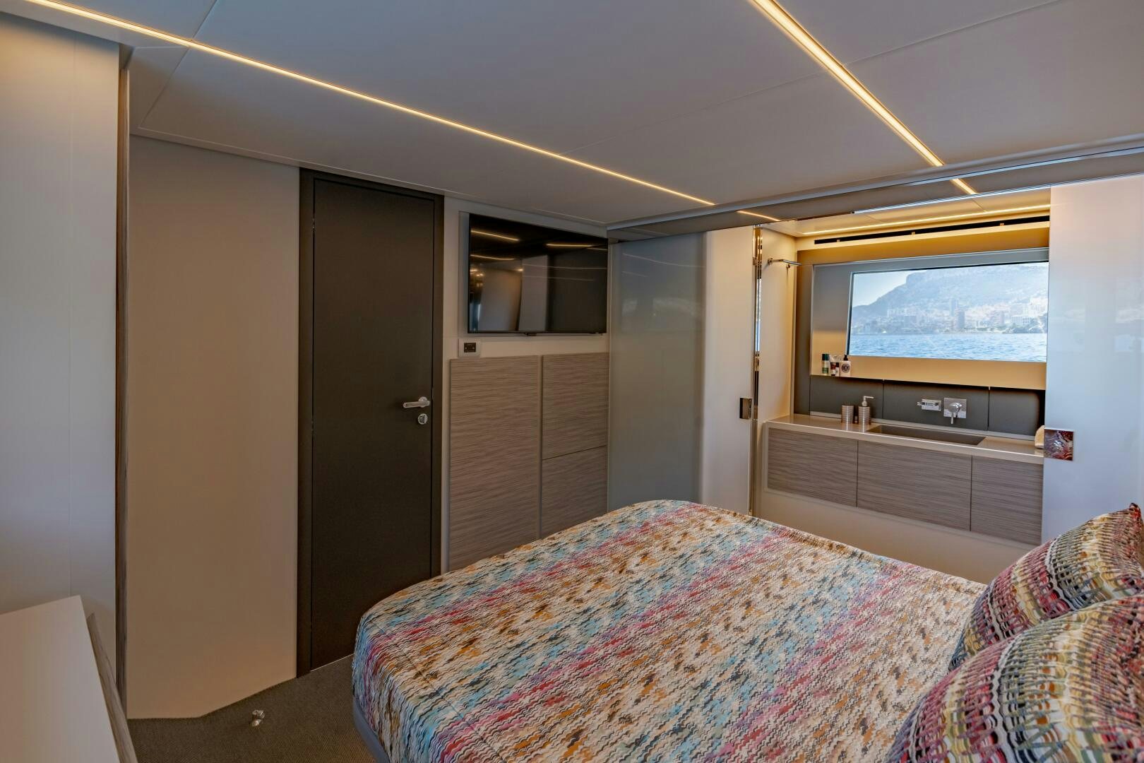 a bedroom with a tv and dresser aboard SILVER MISSILE Yacht for Sale