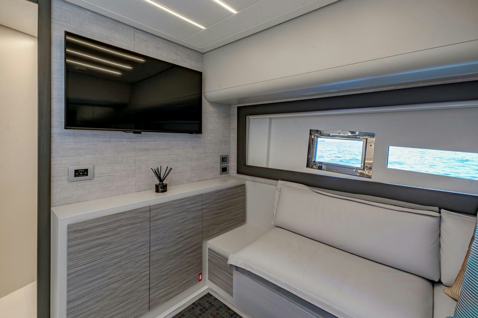 a room with a couch and a television aboard SILVER MISSILE Yacht for Sale