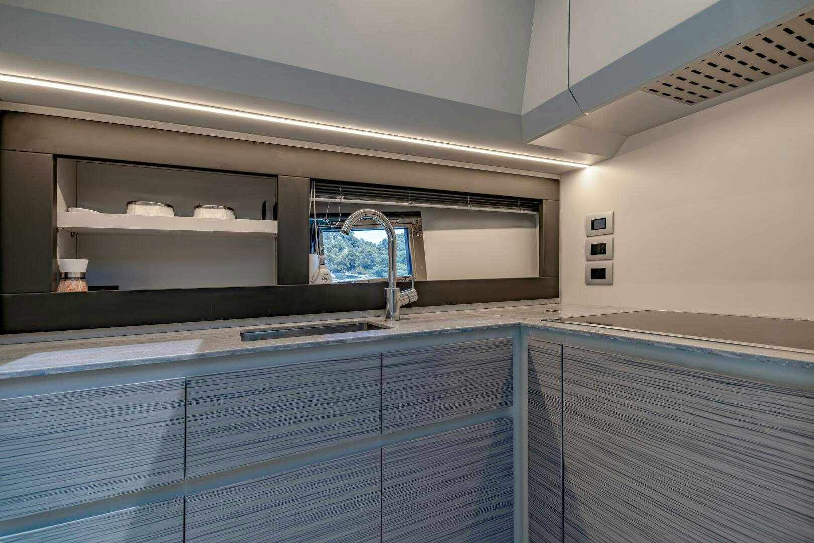 a kitchen with a sink and a window aboard SILVER MISSILE Yacht for Sale