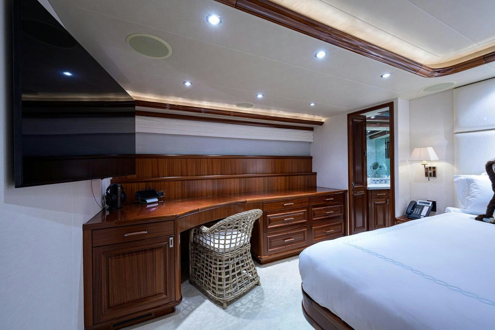 a bedroom with a bed and desk aboard CERCA TROVA Yacht for Sale