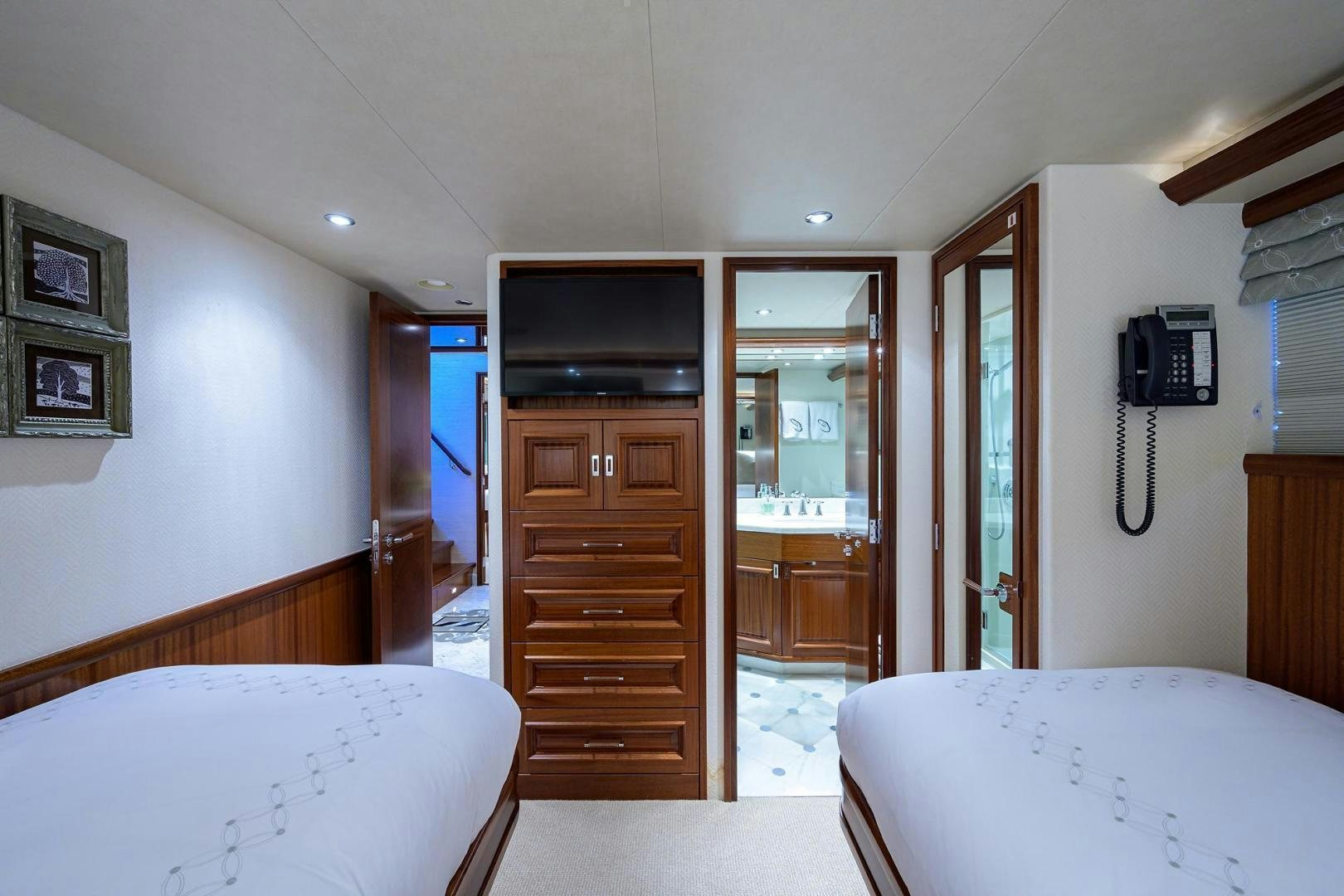 a bedroom with a bed and a television aboard CERCA TROVA Yacht for Sale