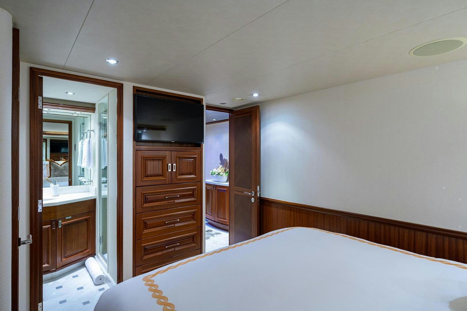 a bedroom with a bed and a television aboard CERCA TROVA Yacht for Sale