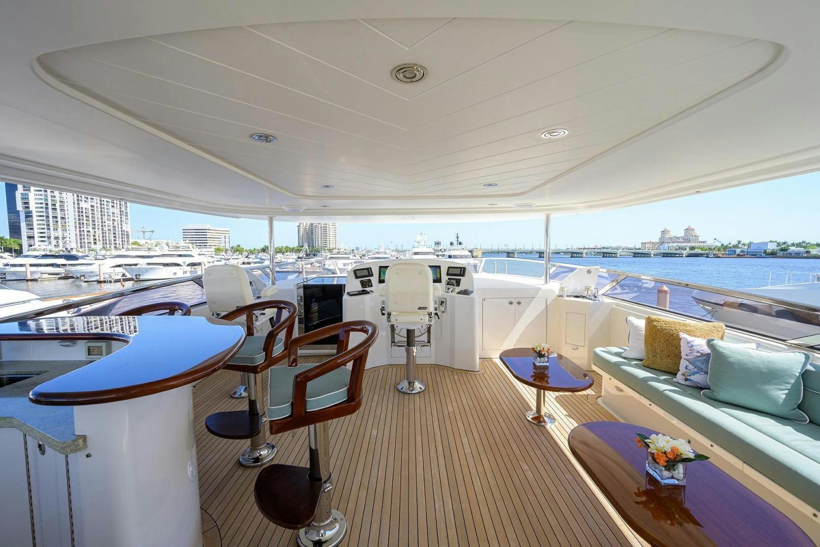 a room with a table chairs and a large window overlooking a city aboard CERCA TROVA Yacht for Sale