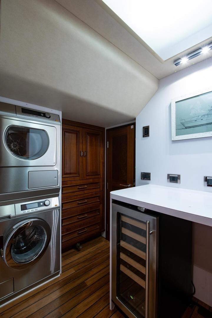 a kitchen with wooden cabinets aboard CERCA TROVA Yacht for Sale