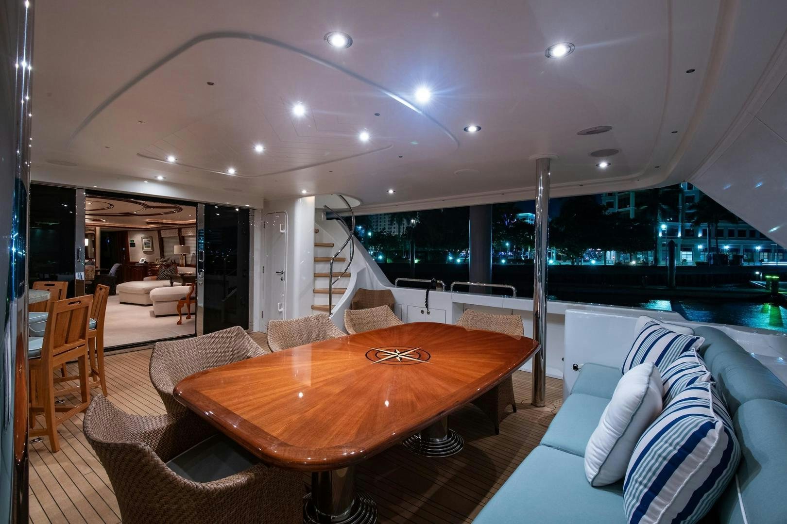 a large living room with a table and chairs aboard CERCA TROVA Yacht for Sale