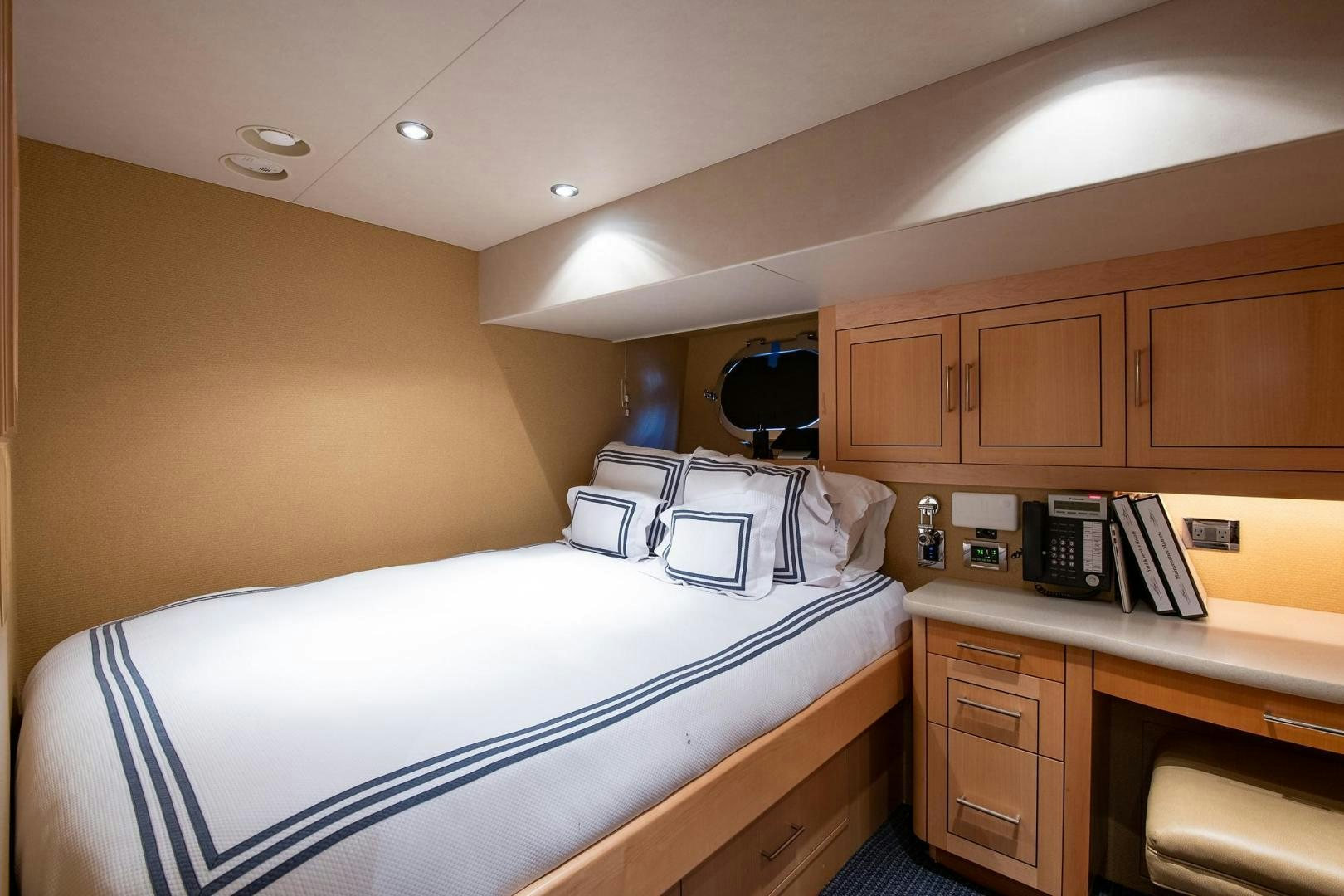 a bedroom with a bed and desk aboard CERCA TROVA Yacht for Sale
