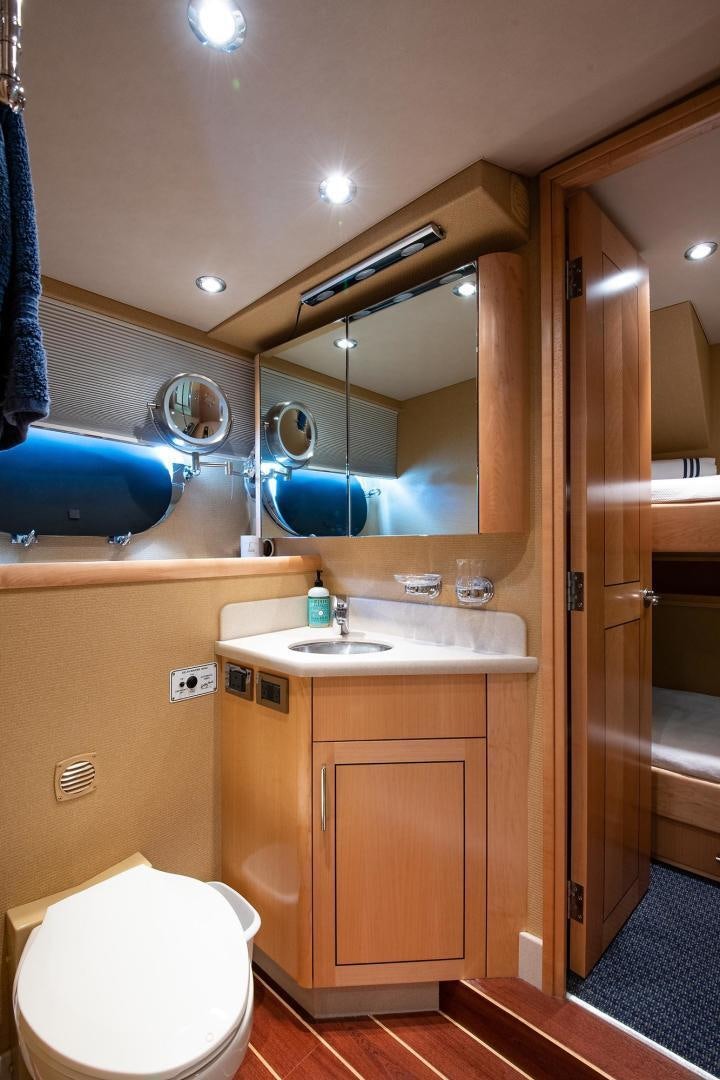a bathroom with a toilet and a sink aboard CERCA TROVA Yacht for Sale