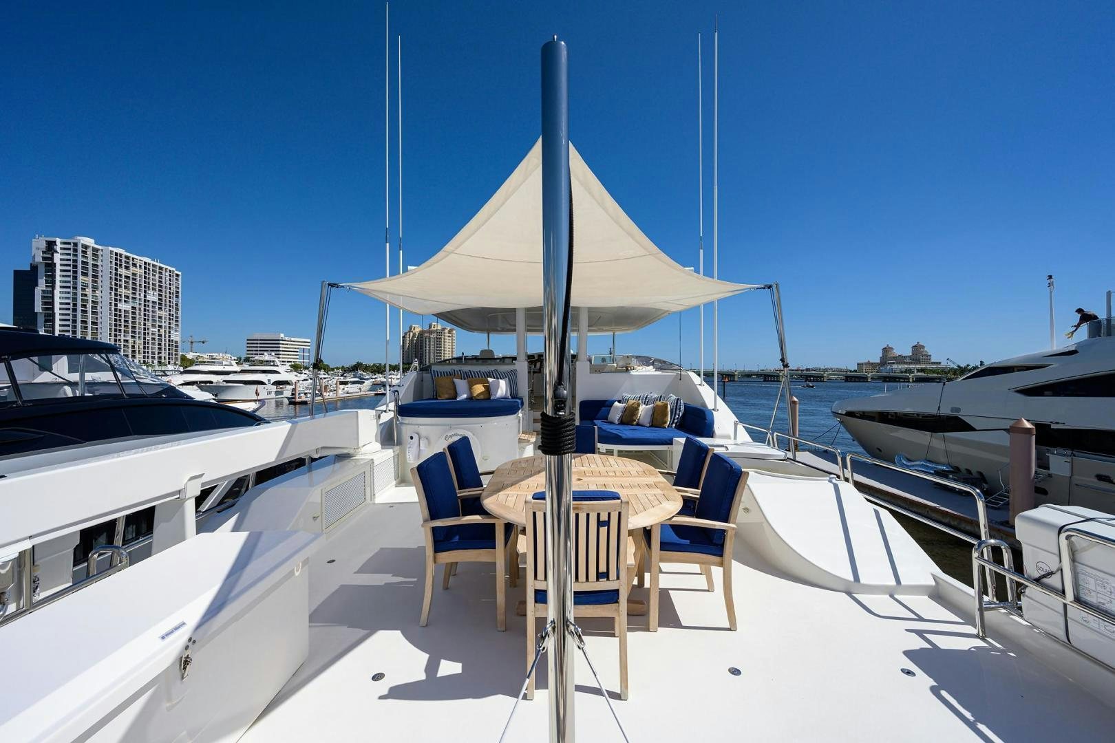 a boat dock with a table and umbrella aboard CERCA TROVA Yacht for Sale
