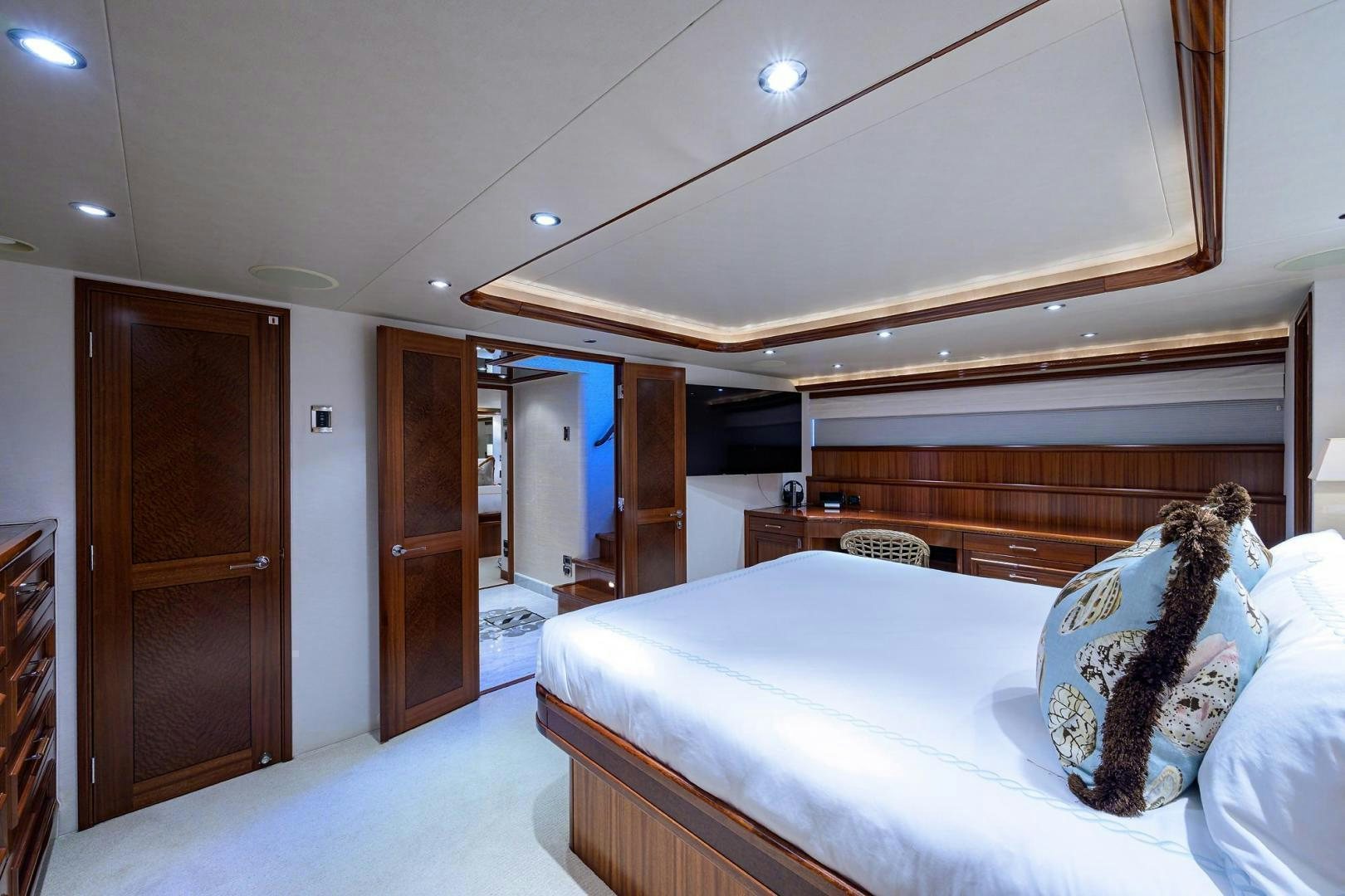 a bedroom with a bed and a closet aboard CERCA TROVA Yacht for Sale