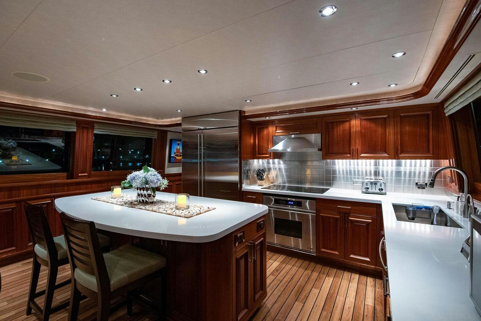 a kitchen with wooden cabinets aboard CERCA TROVA Yacht for Sale