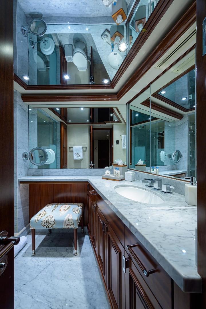 a bathroom with a sink and a bed aboard CERCA TROVA Yacht for Sale