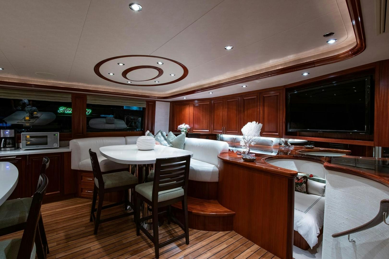 a kitchen with a bar and a table and chairs aboard CERCA TROVA Yacht for Sale