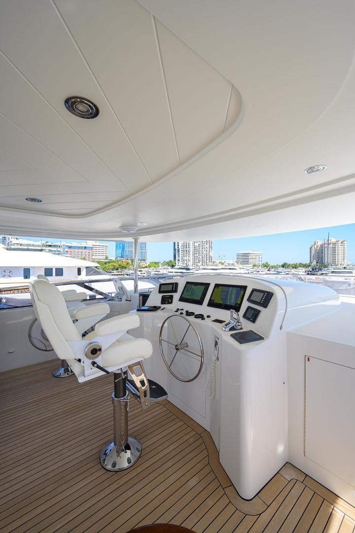 a room with a large window and a table with chairs and a large window with a view of aboard CERCA TROVA Yacht for Sale