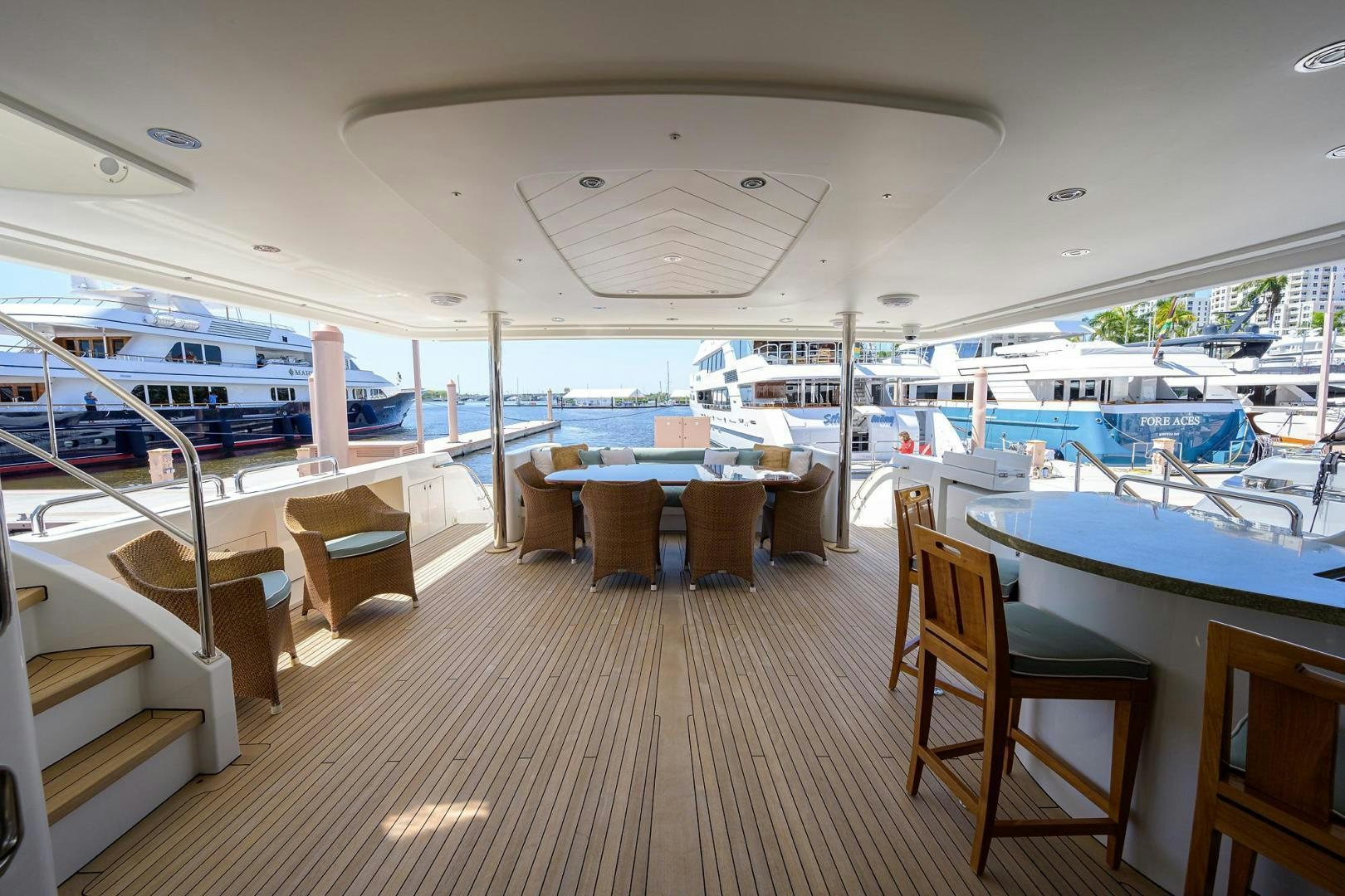 a boat dock with tables and chairs aboard CERCA TROVA Yacht for Sale
