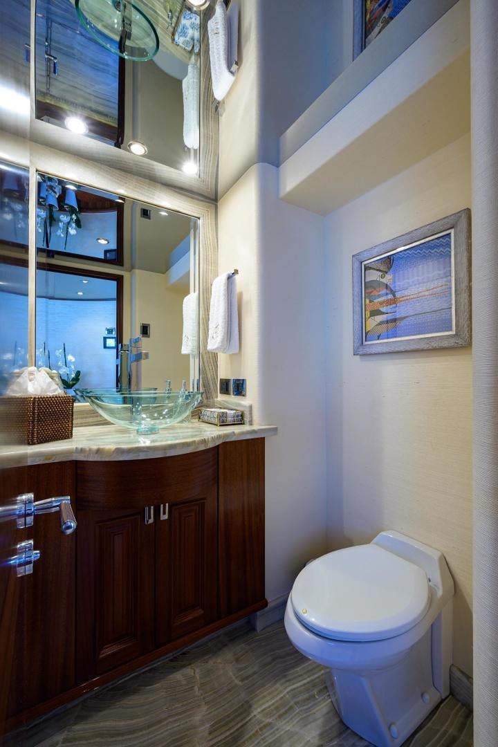 a bathroom with a toilet and a mirror aboard CERCA TROVA Yacht for Sale