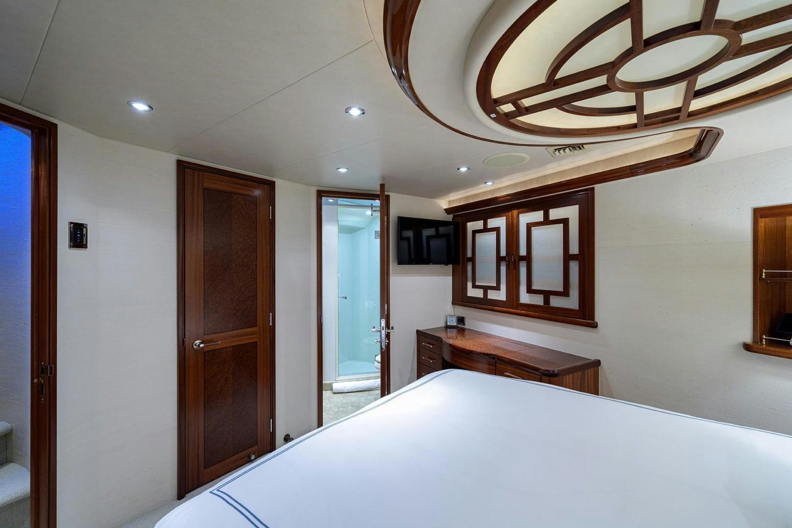 a bedroom with a bed and a desk aboard CERCA TROVA Yacht for Sale