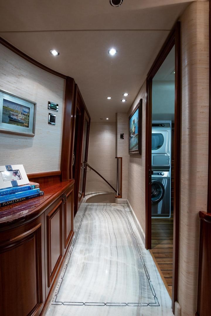 a hallway with a television and a table aboard CERCA TROVA Yacht for Sale