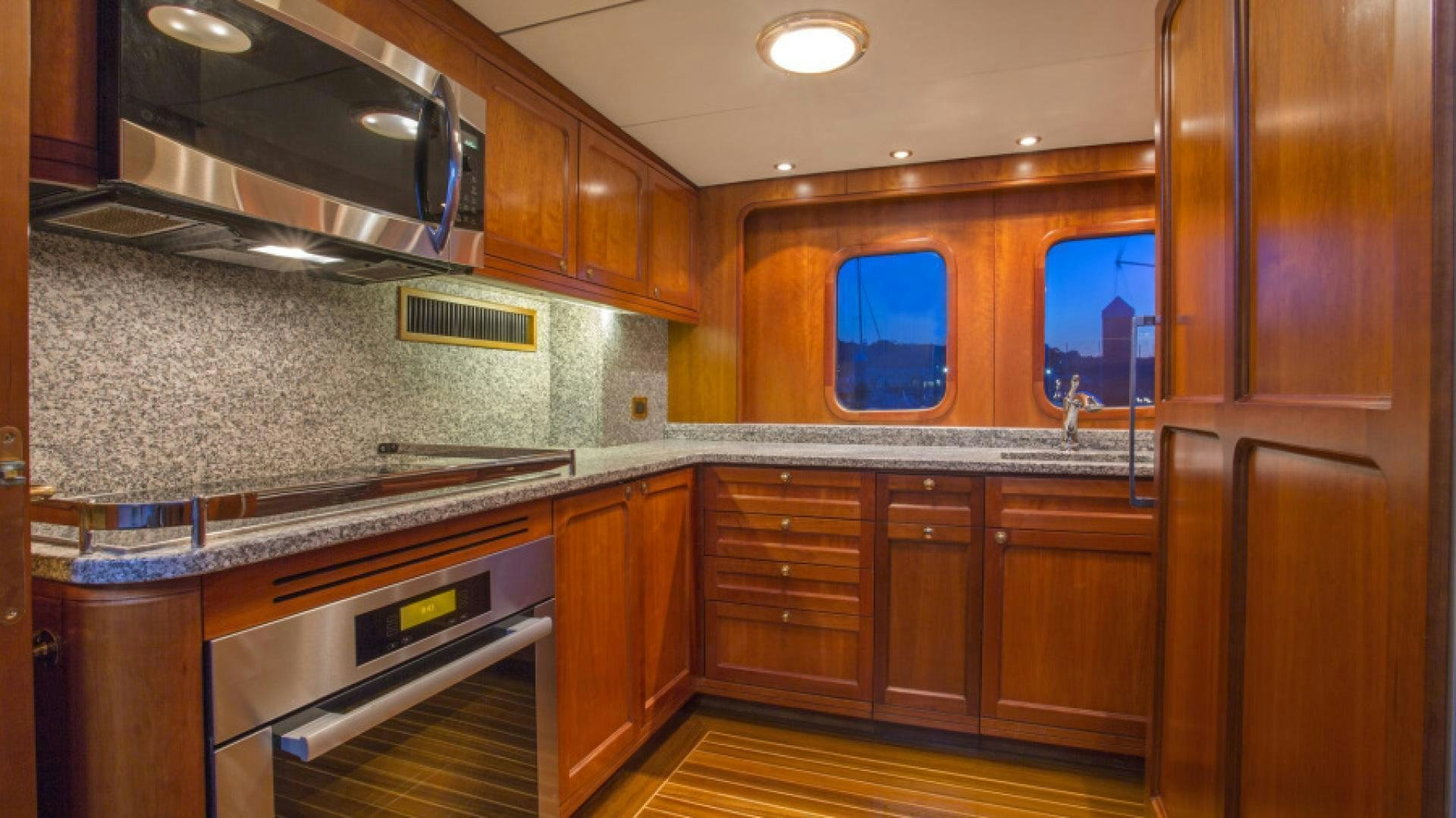 a kitchen with wooden cabinets aboard MYU Yacht for Sale